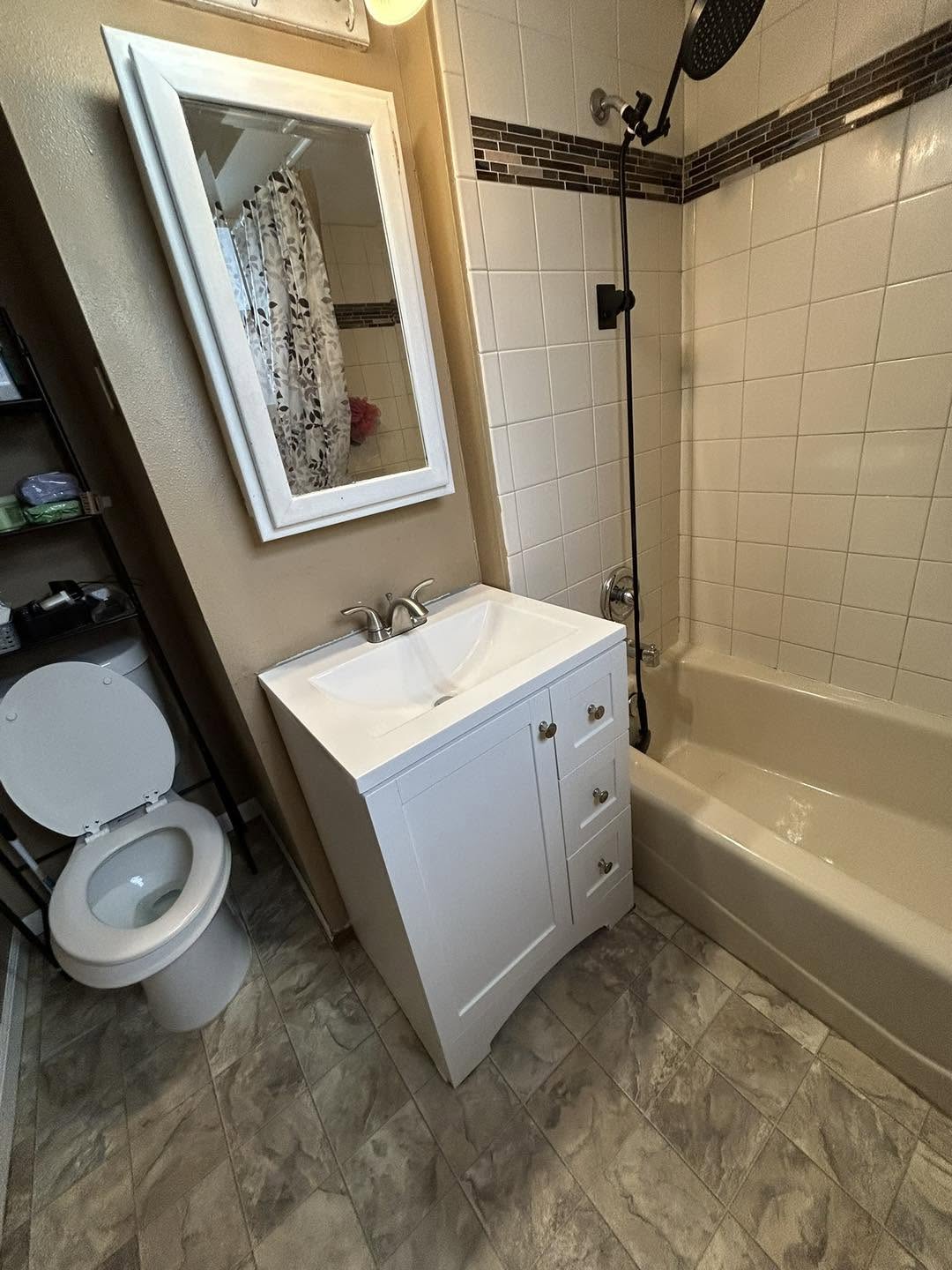 Bathroom reset for turnover: white vanity, wiped mirror, and a scrubbed tub