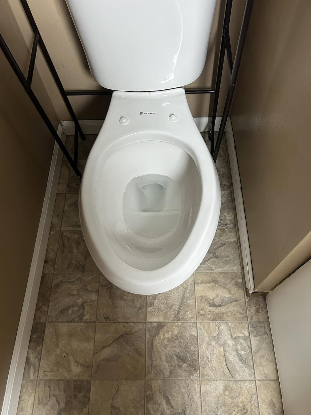 The same toilet after sanitizing, bowl and floor spotless